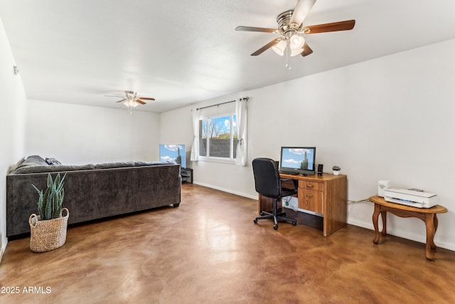 home office with ceiling fan, concrete floors, and baseboards