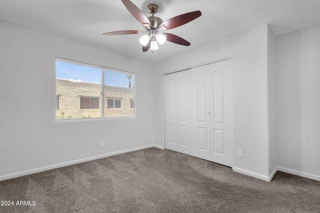 unfurnished bedroom featuring a closet, ceiling fan, and carpet floors