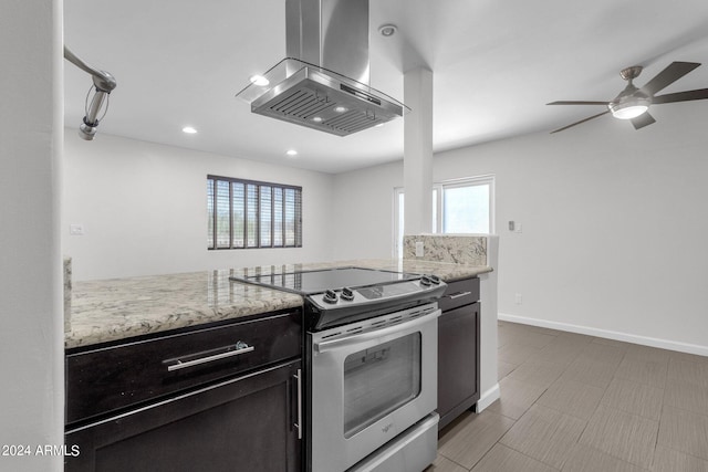 kitchen with island exhaust hood, ceiling fan, stainless steel range with electric cooktop, and light stone counters