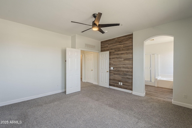 1886 E Don Carlos Ave Unit 136, Tempe, AZ 85281 - unfurnished bedroom with arched walkways, carpet floors, ensuite bathroom, and ceiling fan