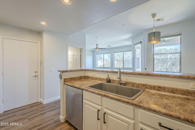 1886 E Don Carlos Ave Unit 136, Tempe, AZ 85281 - kitchen with stainless steel dishwasher, wood finished floors, hanging light fixtures, recessed lighting, and white cabinetry