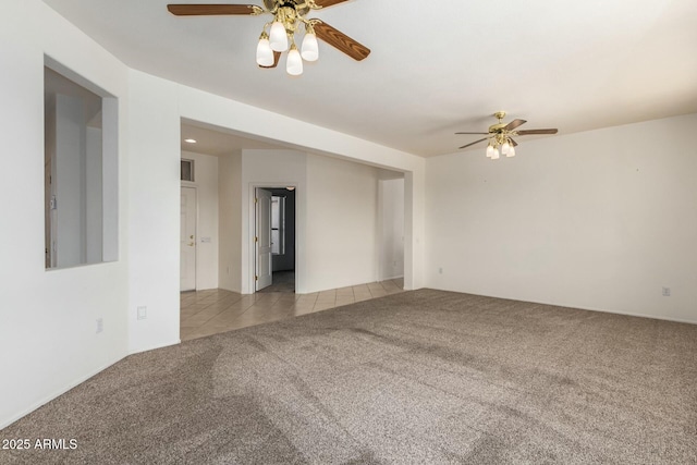 carpeted spare room featuring ceiling fan