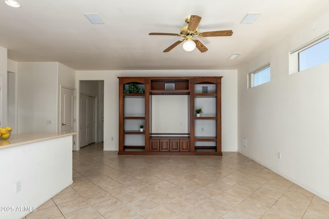 unfurnished living room with light tile patterned floors and ceiling fan