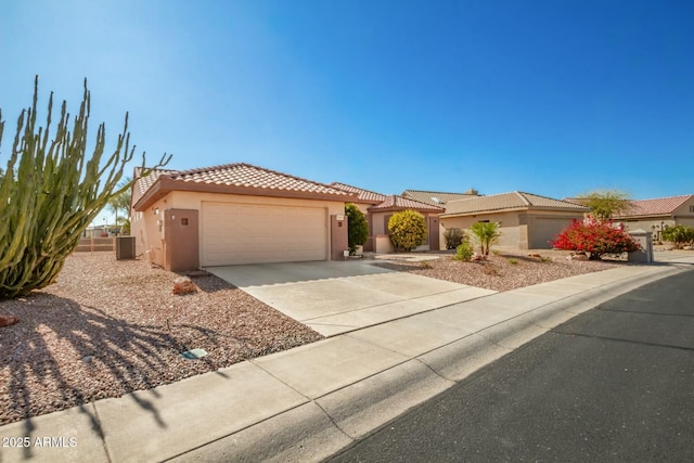 view of front of property with a garage and central AC unit