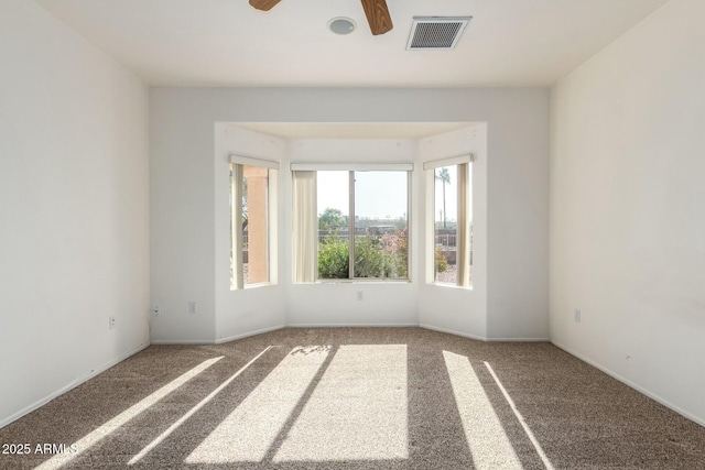 spare room with carpet floors and ceiling fan