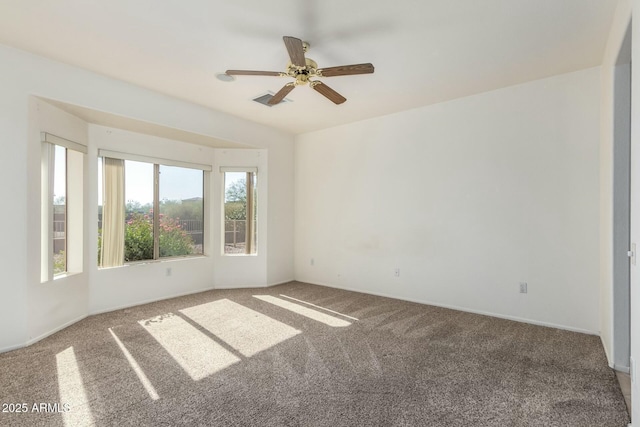 carpeted spare room with ceiling fan