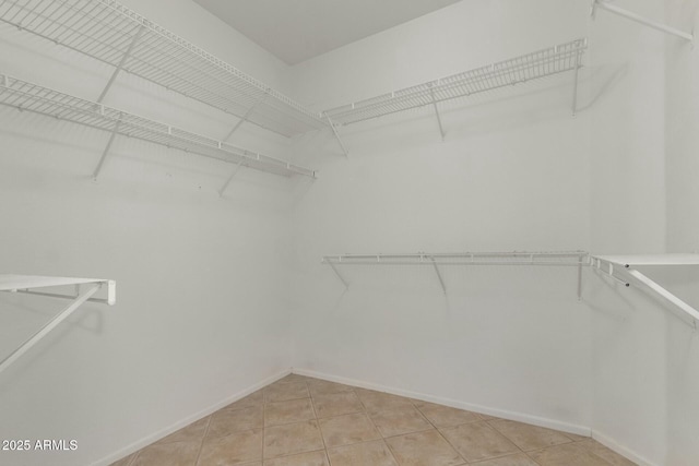 walk in closet with tile patterned floors