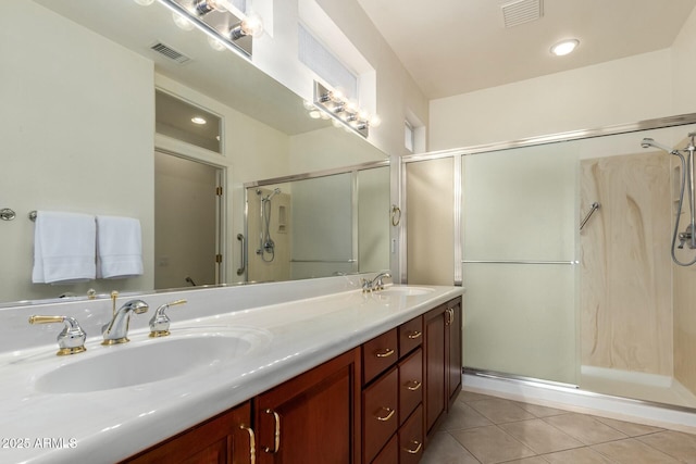 bathroom with vanity, an enclosed shower, and tile patterned flooring