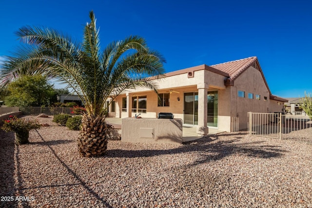 back of property with a patio