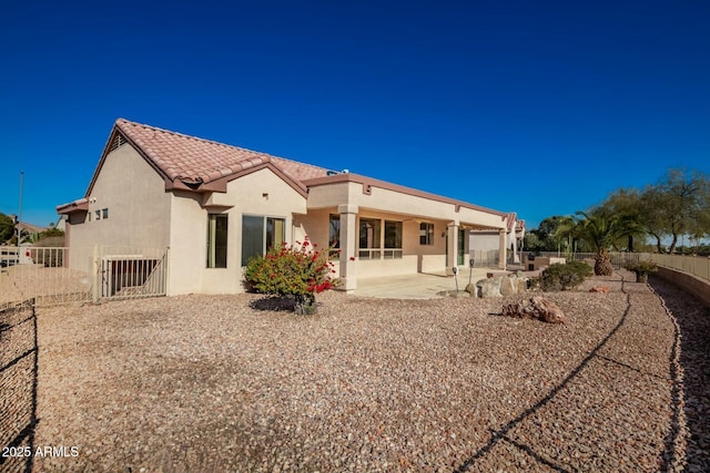 back of house with a patio area