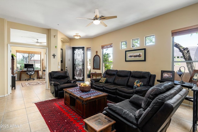 living room with light tile patterned floors, ceiling fan, and a wealth of natural light