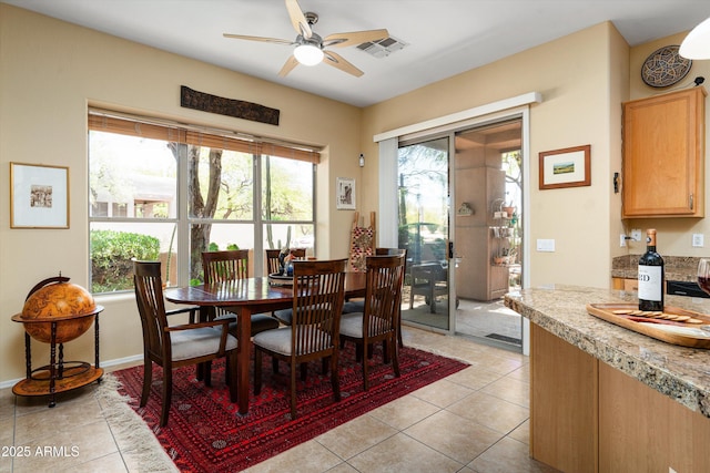 dining room featuring light tile patterned floors, visible vents, and ceiling fan