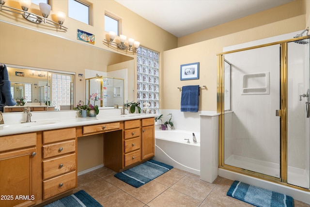 full bath featuring tile patterned floors, a shower stall, double vanity, a sink, and a garden tub