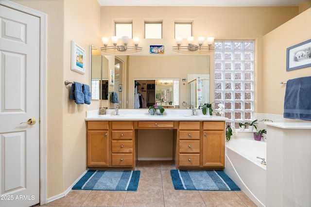 full bath featuring a bath, double vanity, a notable chandelier, and tile patterned floors