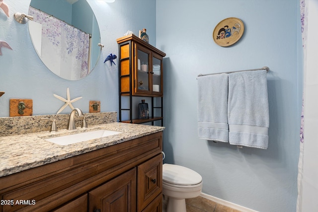 full bath featuring tile patterned floors, vanity, toilet, and baseboards