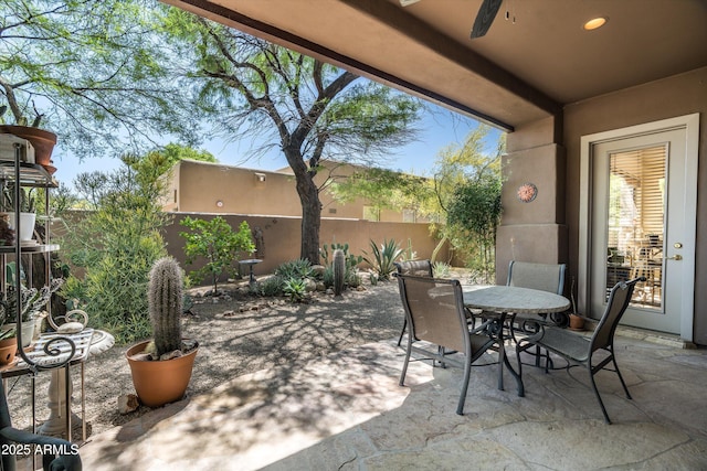 view of patio featuring ceiling fan, a fenced backyard, and outdoor dining area