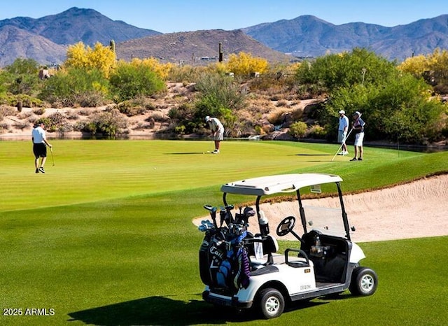 view of property's community featuring a mountain view and view of golf course