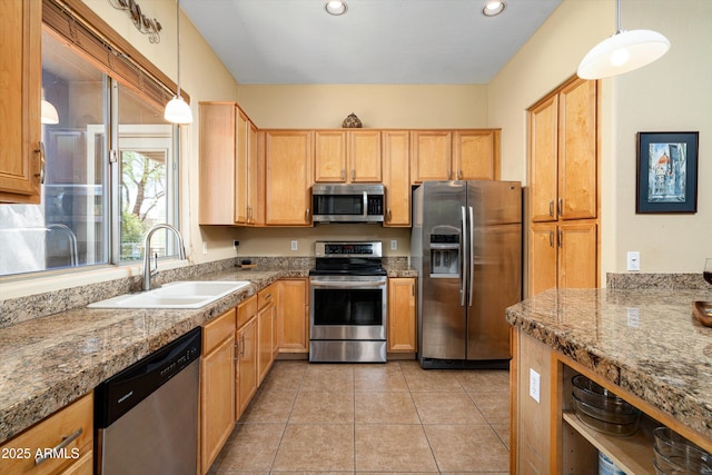 kitchen with recessed lighting, a sink, stainless steel appliances, light tile patterned floors, and hanging light fixtures