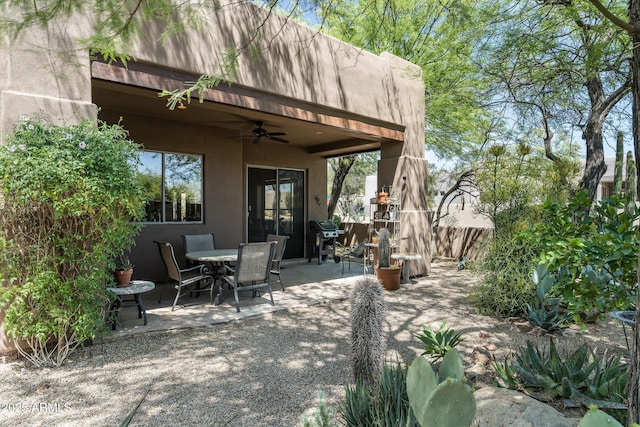 view of patio / terrace with fence, outdoor dining space, ceiling fan, and a grill