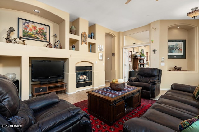 living room featuring recessed lighting, built in shelves, a ceiling fan, baseboards, and tile patterned flooring
