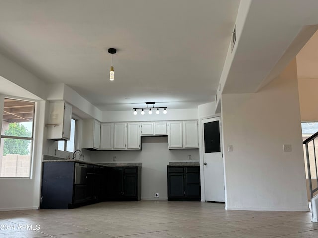 kitchen with white cabinetry, sink, decorative light fixtures, and track lighting