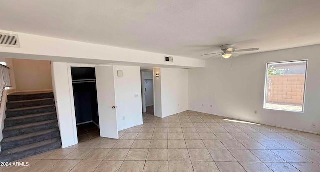 unfurnished bedroom featuring ceiling fan and light tile patterned floors