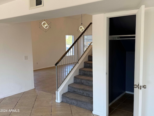 staircase featuring tile patterned floors