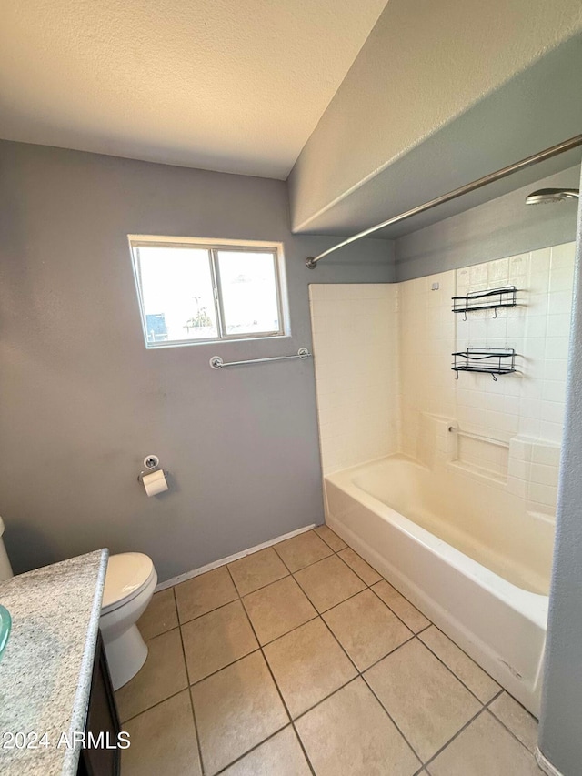 full bathroom with washtub / shower combination, tile patterned floors, toilet, a textured ceiling, and vanity