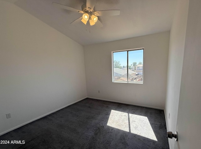 empty room with dark colored carpet and ceiling fan