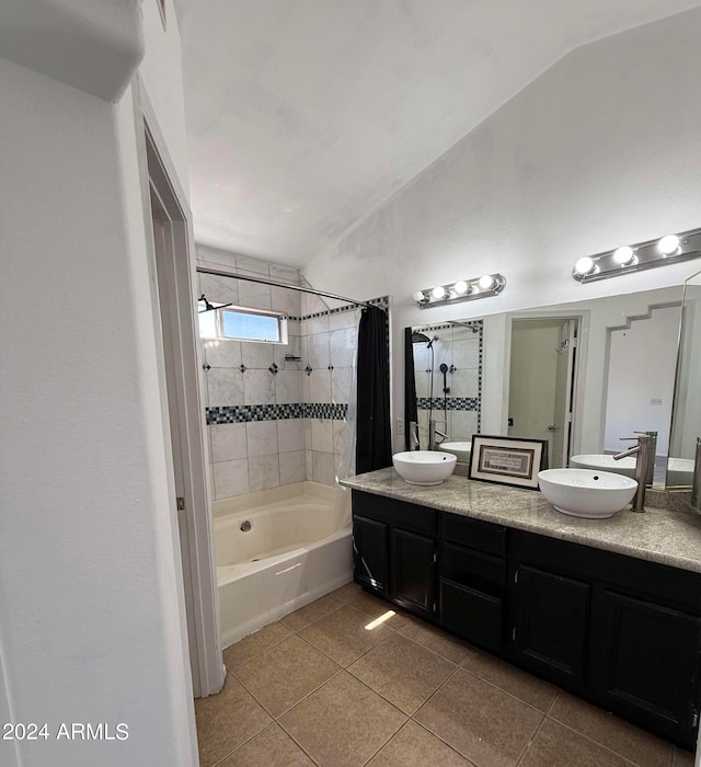 bathroom with tile patterned floors, vaulted ceiling, vanity, and shower / bath combo