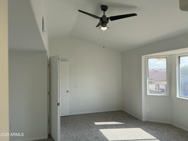 spare room with lofted ceiling, carpet flooring, and ceiling fan