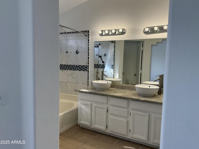 bathroom featuring vanity, tiled shower / bath combo, and tile patterned floors