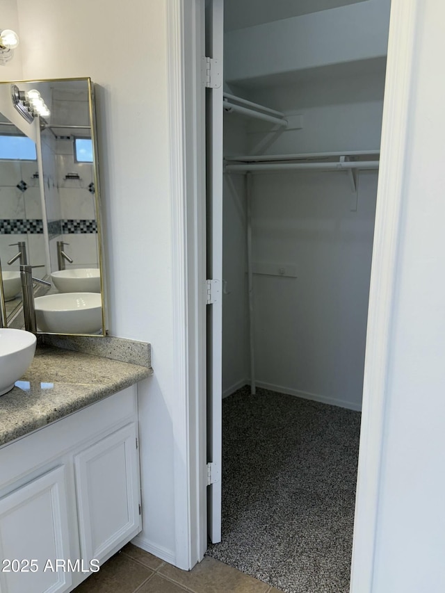 bathroom with tile patterned flooring and vanity