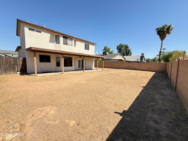 back of property with a patio