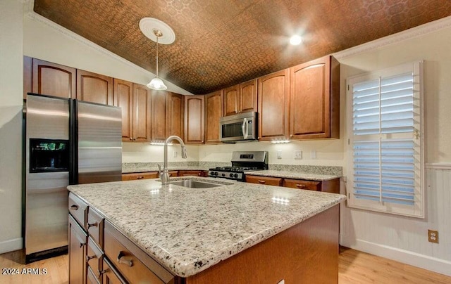 kitchen featuring pendant lighting, an island with sink, and appliances with stainless steel finishes