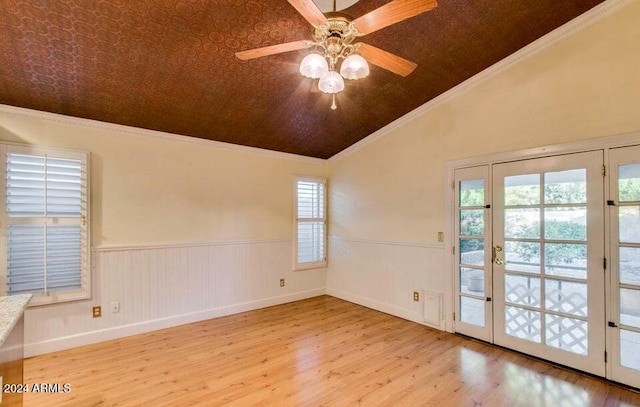 unfurnished room with crown molding, vaulted ceiling, ceiling fan, plenty of natural light, and light hardwood / wood-style floors