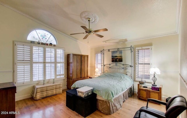 bedroom with ceiling fan, crown molding, vaulted ceiling, and light wood-type flooring