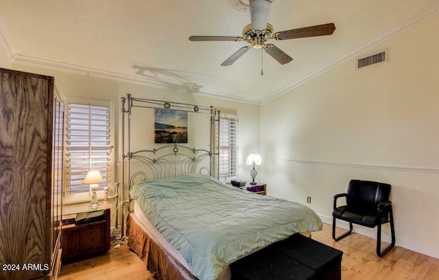 bedroom featuring ceiling fan, crown molding, and light wood-type flooring