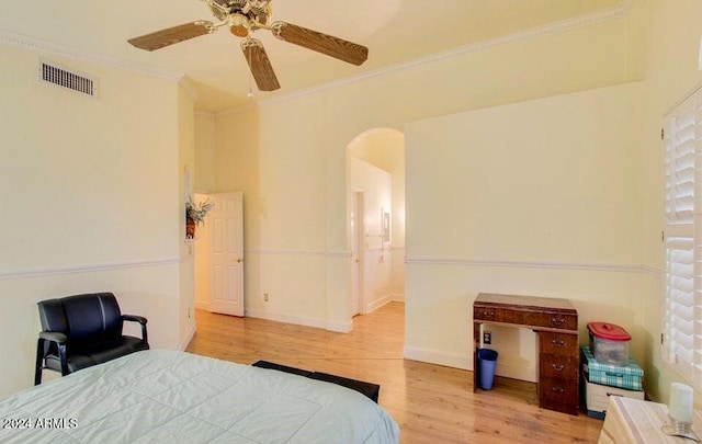 bedroom with light hardwood / wood-style floors, ceiling fan, and ornamental molding