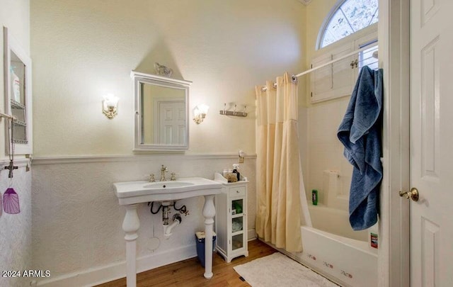 bathroom featuring hardwood / wood-style floors and shower / bath combination with curtain