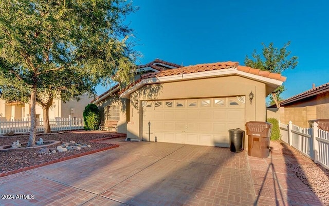 mediterranean / spanish house featuring a garage