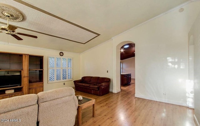 living room featuring light hardwood / wood-style floors, ceiling fan, and ornamental molding