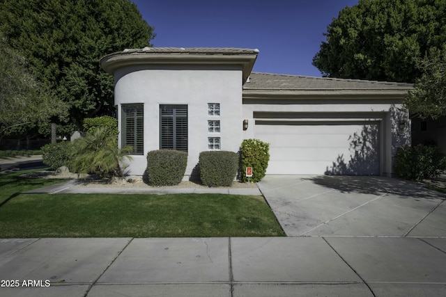 view of front of property featuring a garage and a front lawn