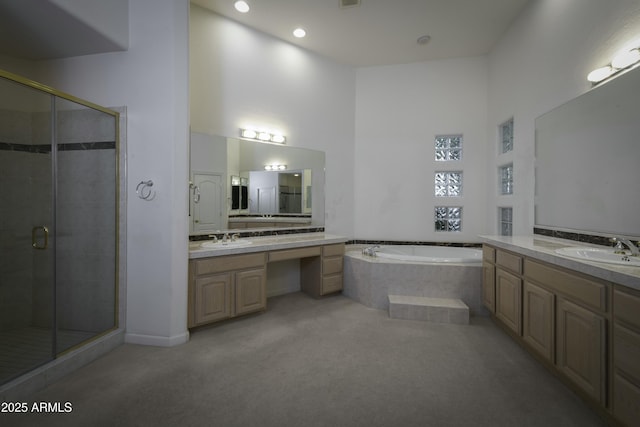 bathroom featuring independent shower and bath, vanity, and a high ceiling