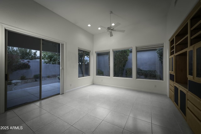 unfurnished sunroom featuring ceiling fan