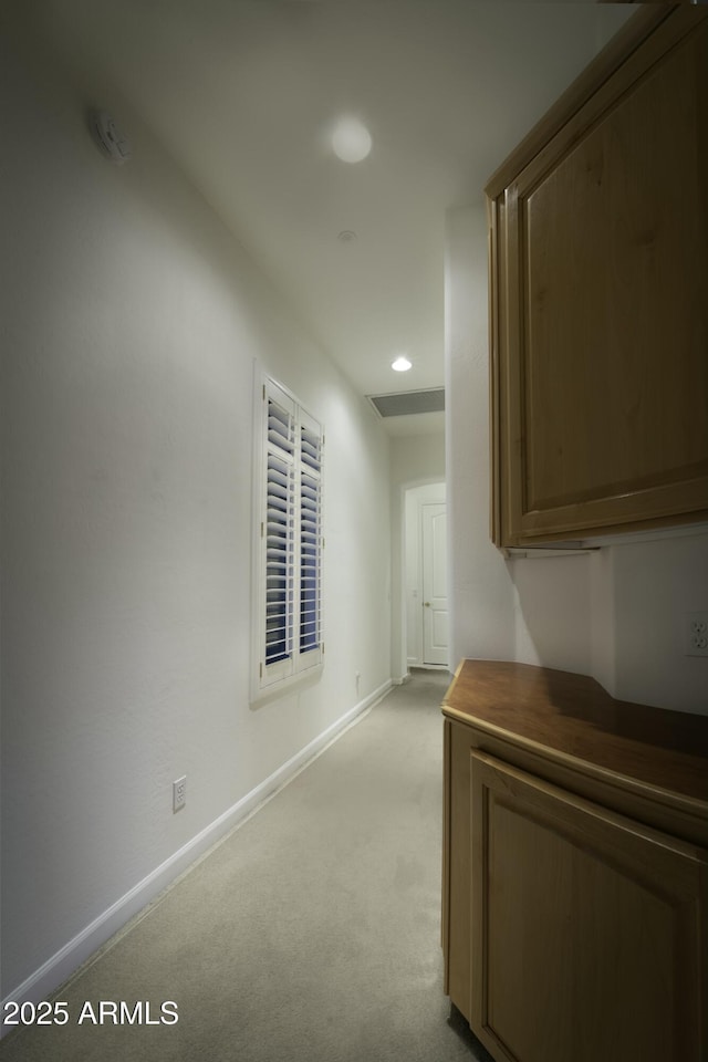 hall featuring light colored carpet