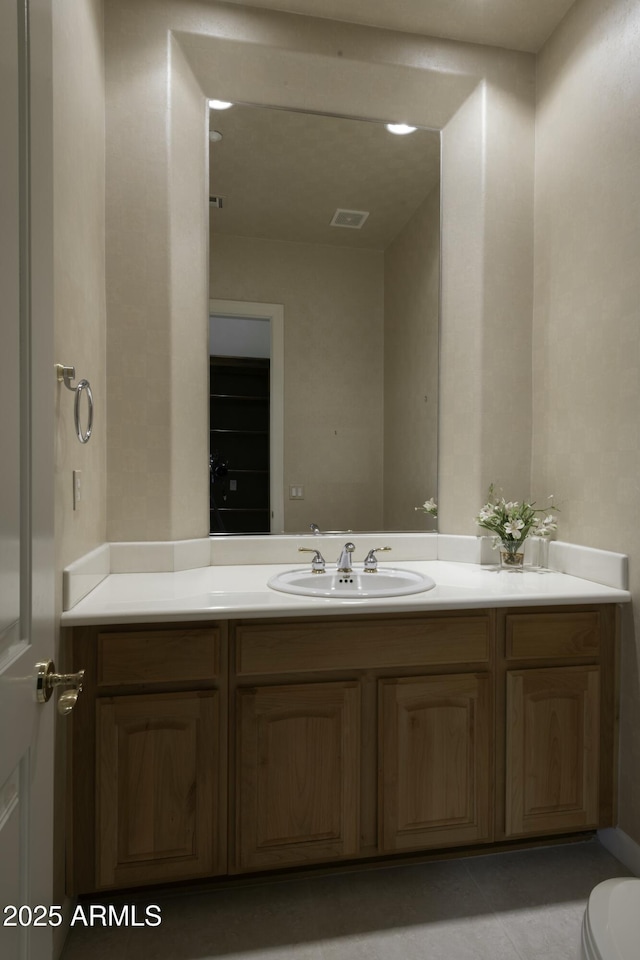 bathroom featuring vanity and toilet