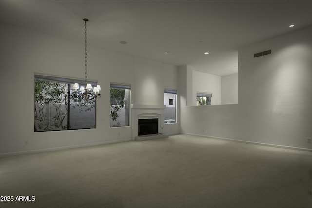 unfurnished living room with an inviting chandelier and a high ceiling