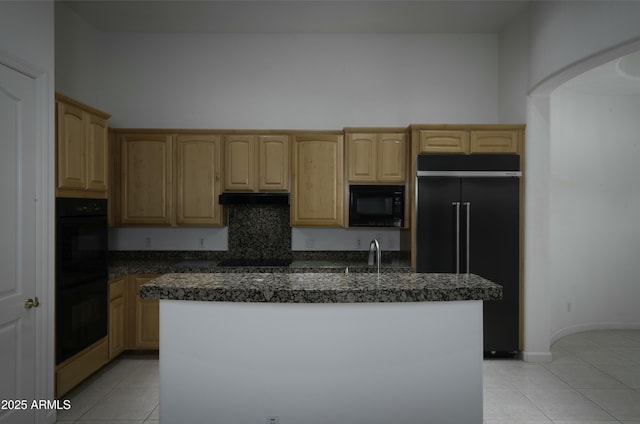 kitchen featuring black appliances, a center island, and light tile patterned flooring