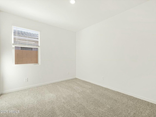 carpeted empty room featuring recessed lighting and baseboards